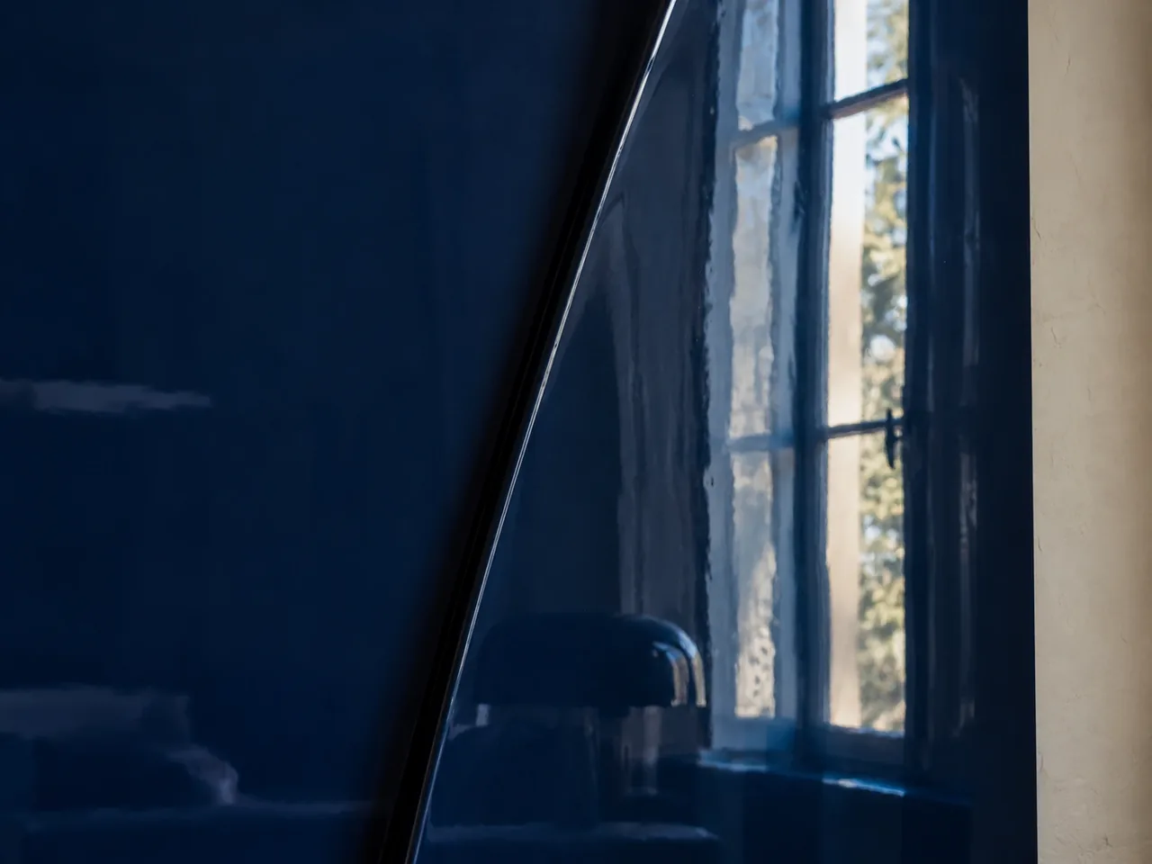 Close-up of the polished metal, with the window reflected in the fold